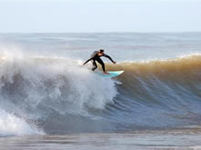 surfista haciendo un truco en una gran ola